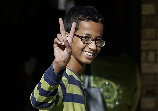 Ahmed Mohamed, 14, gestures as he arrives to his family's home in Irving, Texas, Thursday, Sept. 17, 2015. Ahmed was arrested Monday at his school after a teacher thought a homemade clock he built was a bomb. He remains suspended and said he will not return to classes at MacArthur High School. (AP Photo/LM Otero)
